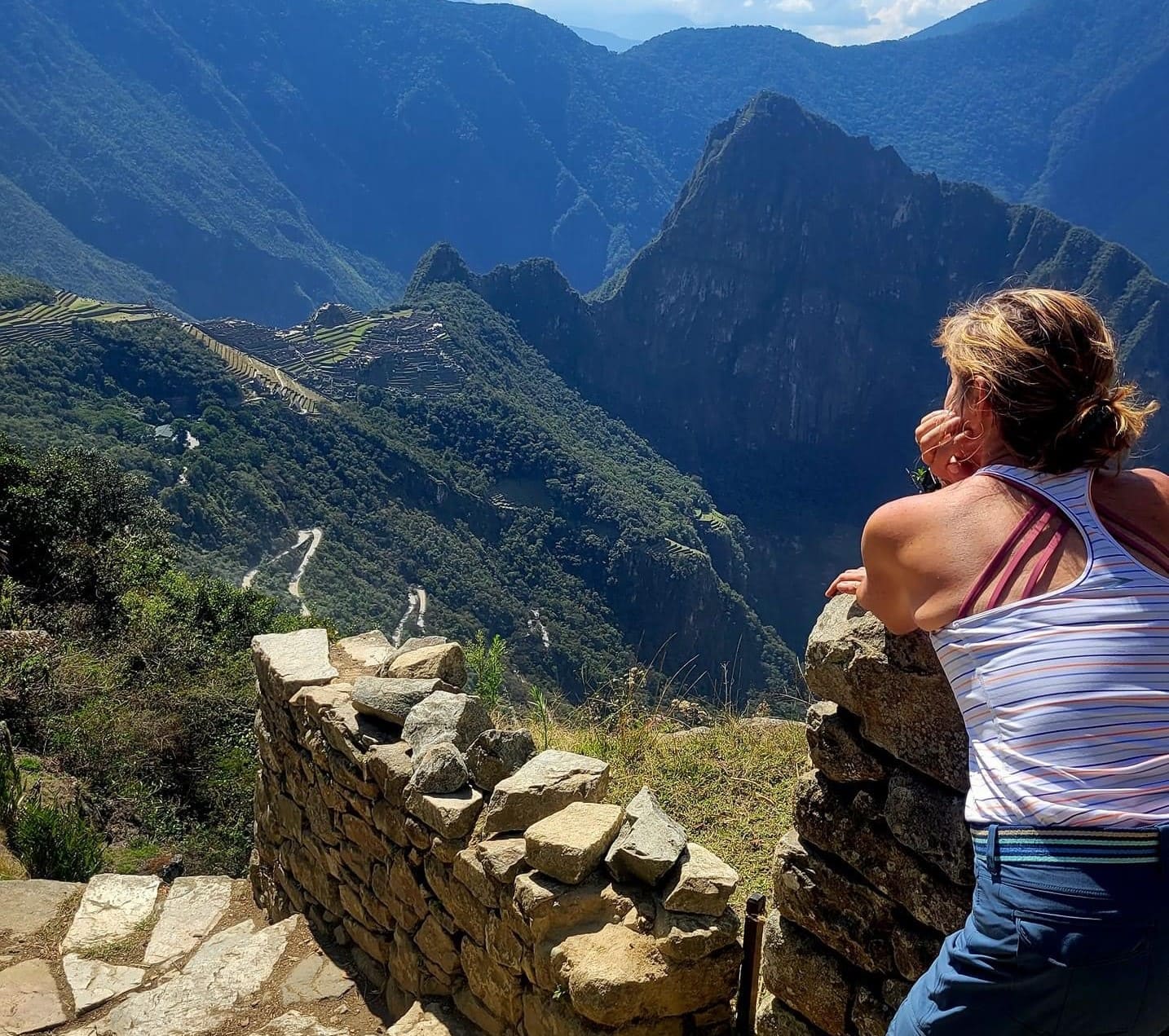 Traveler enjoying the view from the Sun Gate on the Inca Trail to Machu Picchu