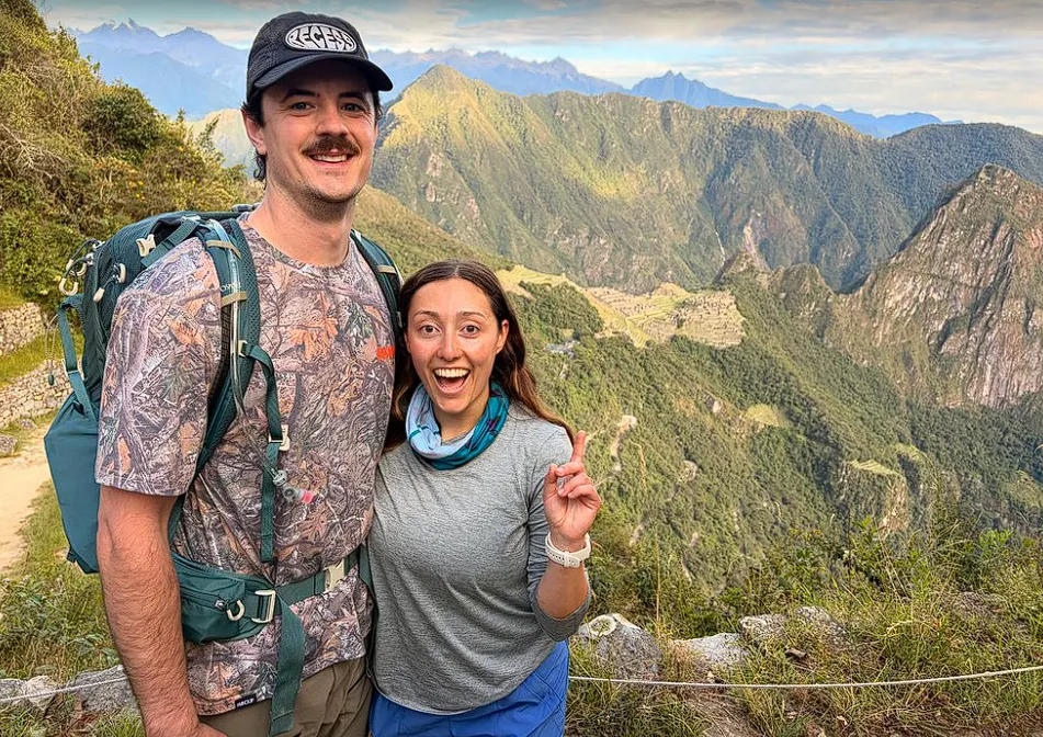 Happy couple enjoying scenic mountain views and ancient ruins on the way to Machu Picchu