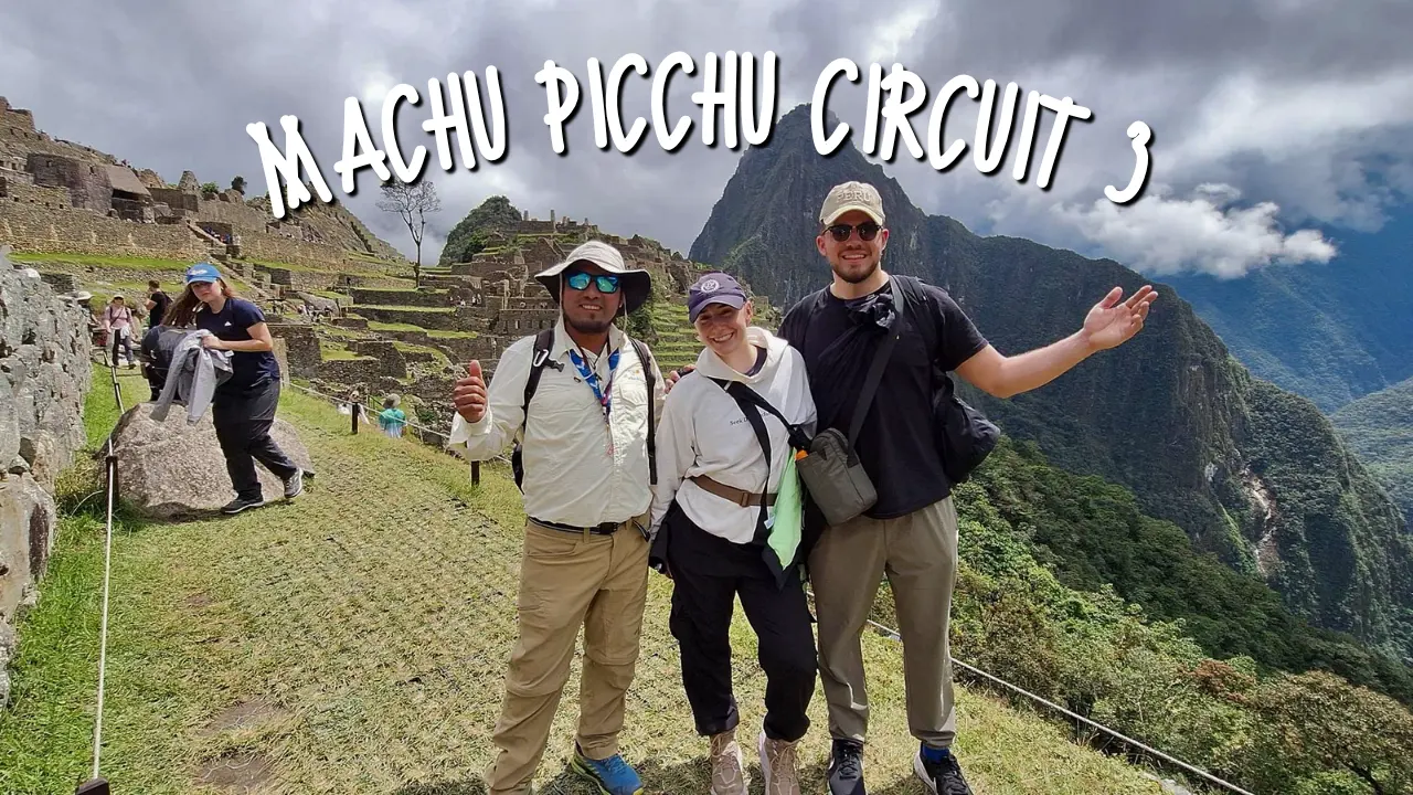 Travelers with a local guide exploring Machu Picchu Circuit 3 with the ruins and surrounding mountains behind them.