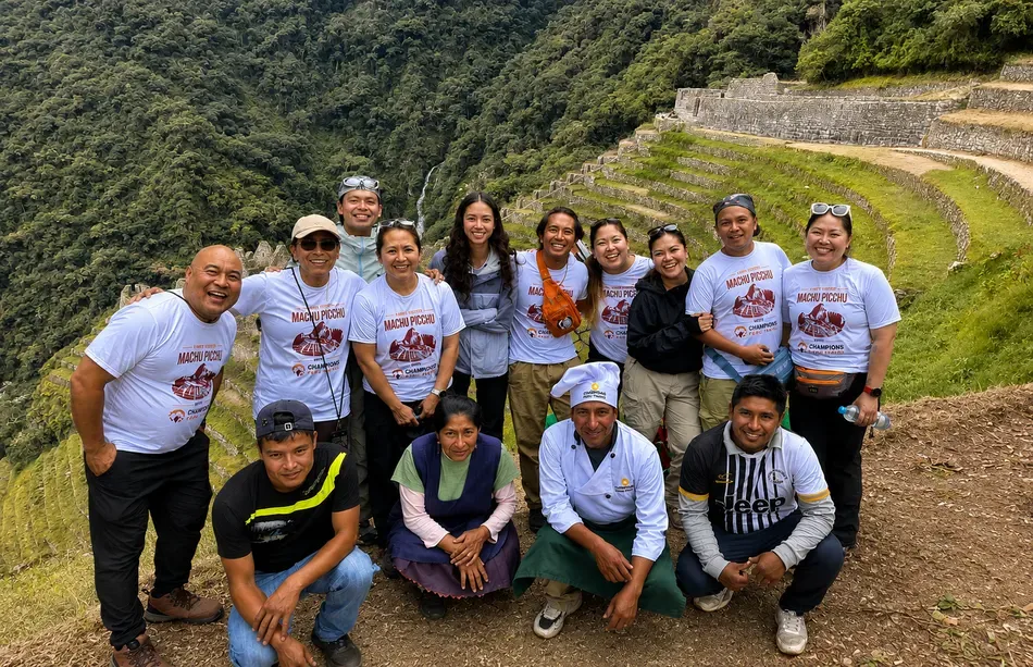 Champions Peru Travel group posing together along the Inca Trail near Machu Picchu terraces
