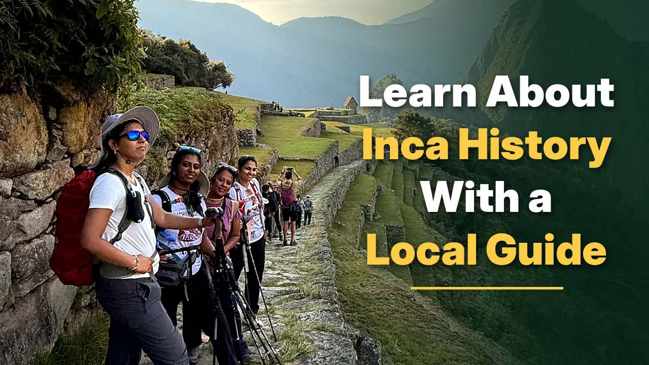 Tourists exploring Machu Picchu with a local guide while learning about Inca history and ancient ruins.