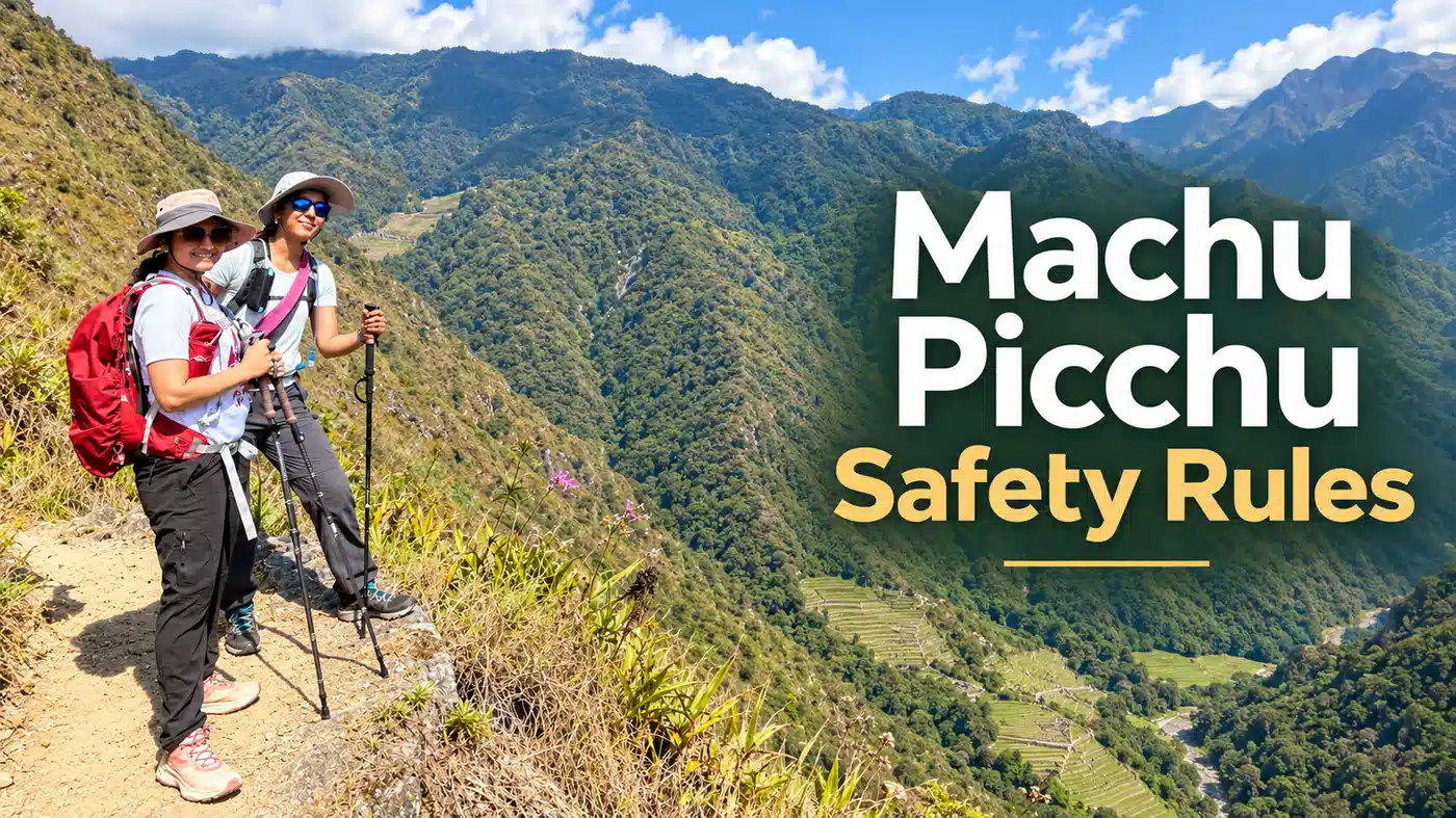 Two female hikers with trekking poles standing on a mountain trail surrounded by the Andes near Machu Picchu