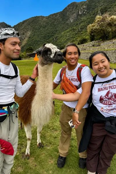  2-day Inca Trail hikers at Machu Picchu with a llama