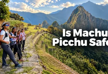Group of tourists standing on a stone pathway overlooking the mountainous landscape surrounding Machu Picchu