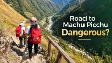 Hikers with backpacks walking along a narrow mountain trail in Peru while following safety tips for traveling to Machu Picchu.